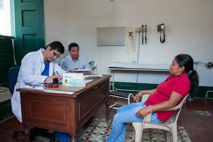 Woman on a chair discussing with a doctor