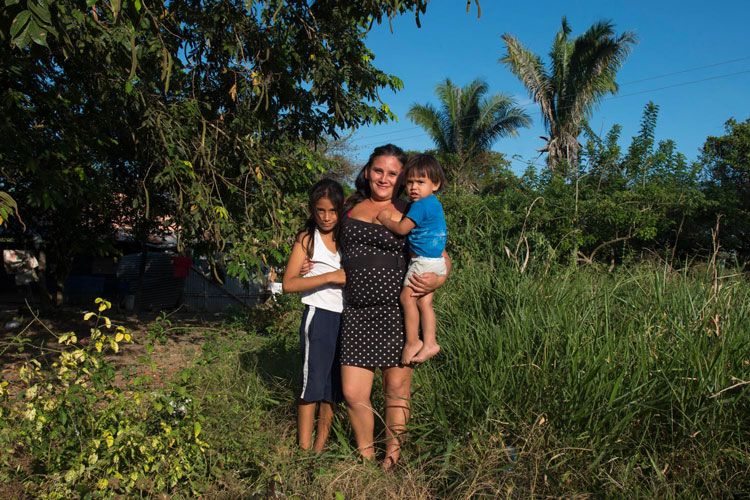 Mother standing with her two child